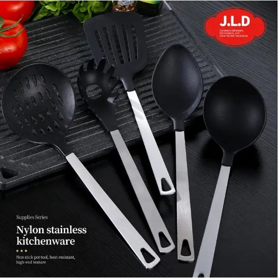 Set of black kitchen utensils with silver handles on a dark surface, featuring the J.L.D brand.