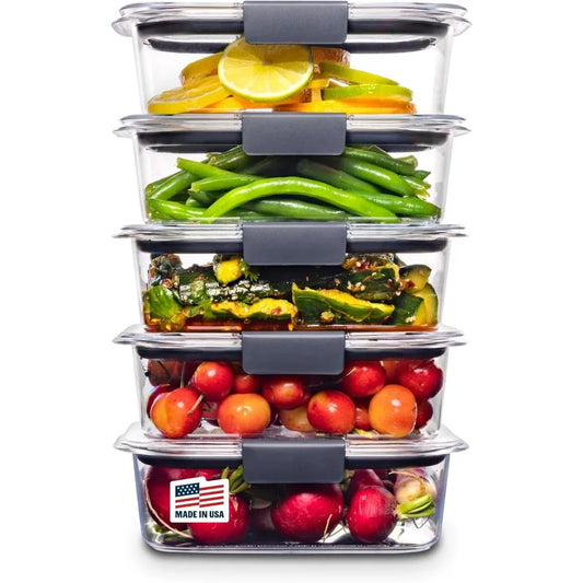 Stack of food storage containers with various vegetables and fruits inside on a white background